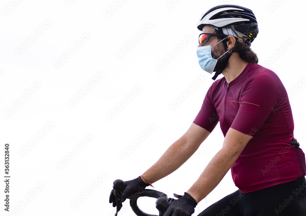 Close-up of a cyclist man wearing a medical mask on a white background Concept: sport and social distance
Close-up of a cyclist man wearing a medical mask on a white background Concept: sport and social distance