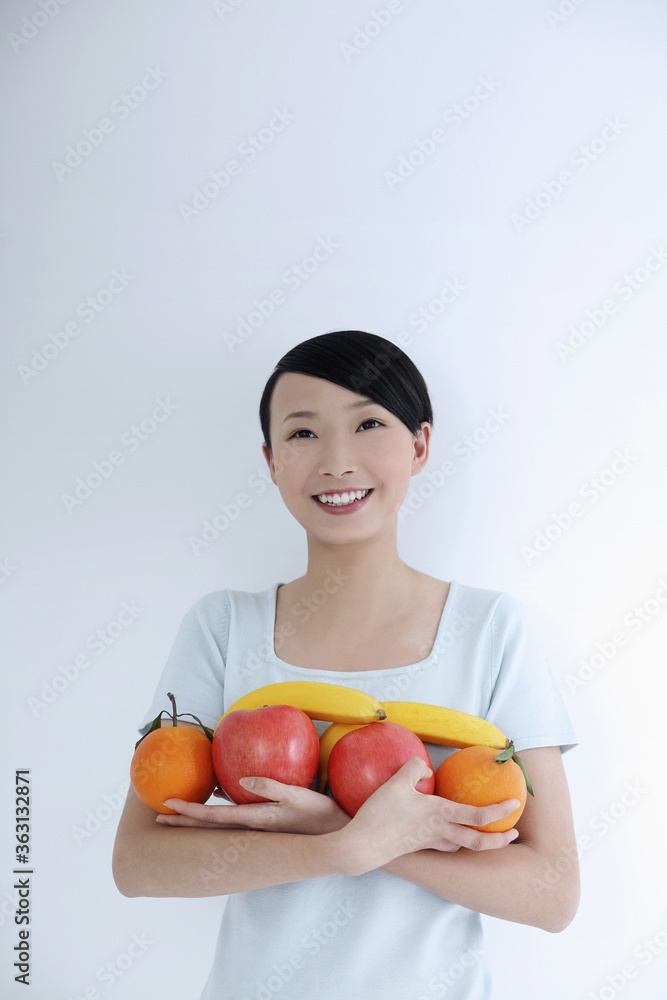 Woman with an armful of fruits Woman with an armful of fruits