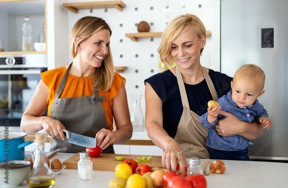 Happy lesbian couple with little daughter at home Happy lesbian couple with little daughter at home