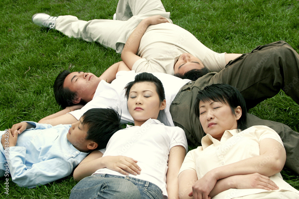 A family sleeping on the grass A family sleeping on the grass