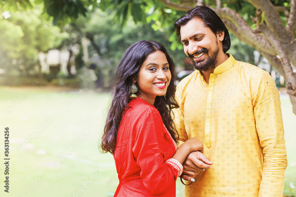 Happy beautiful indian couple wearing traditional clothes holding hands ...