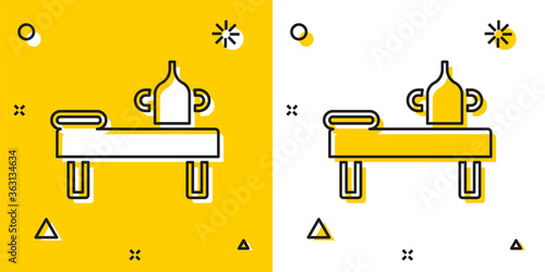 Black Massage table with oil icon isolated on yellow and white background. Random dynamic shapes. Vector.