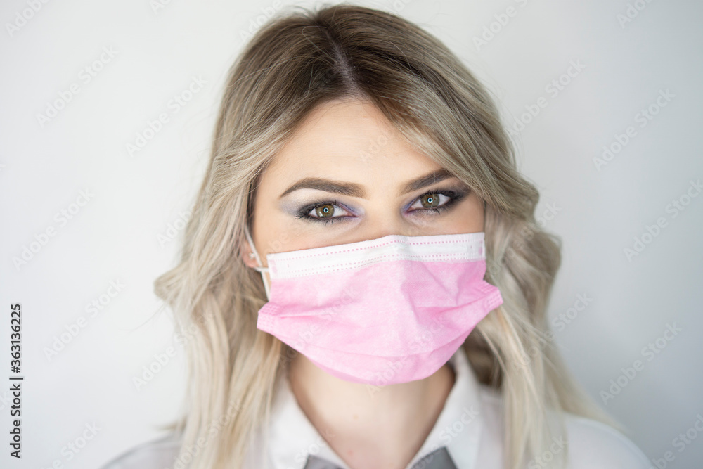 Beautiful blonde girl put on a protective pink mask Beautiful blonde girl put on a protective pink mask
