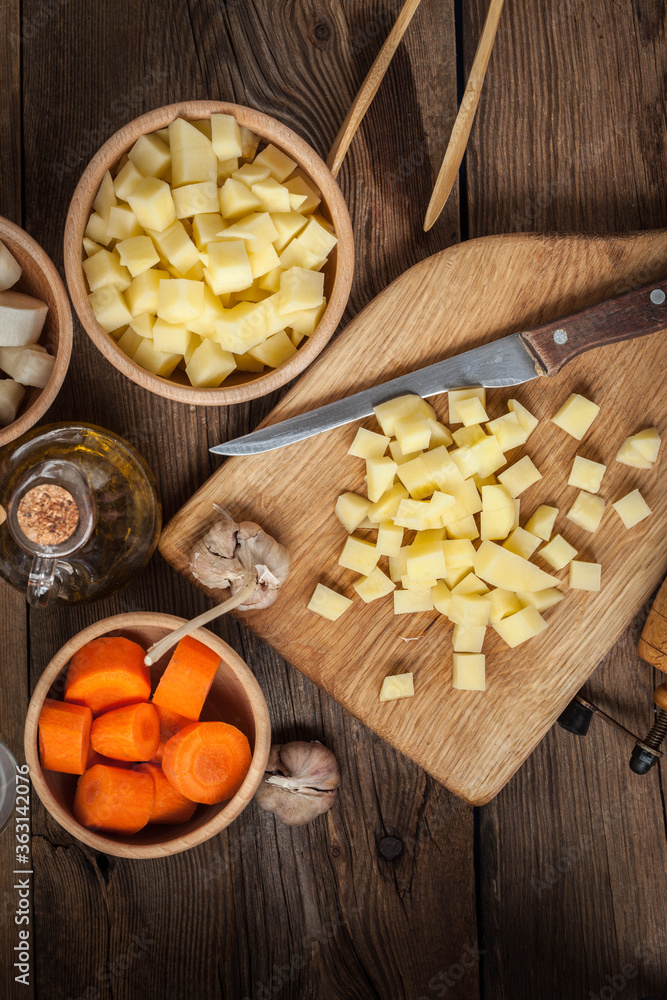 Diced potatoes on a wooden chopping board. Diced potatoes on a wooden chopping board.