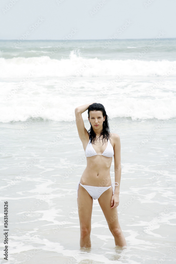 Woman in bikini posing on the beach