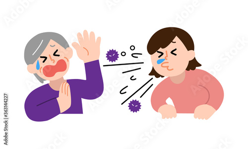 くしゃみする女性と嫌がるシニア女性