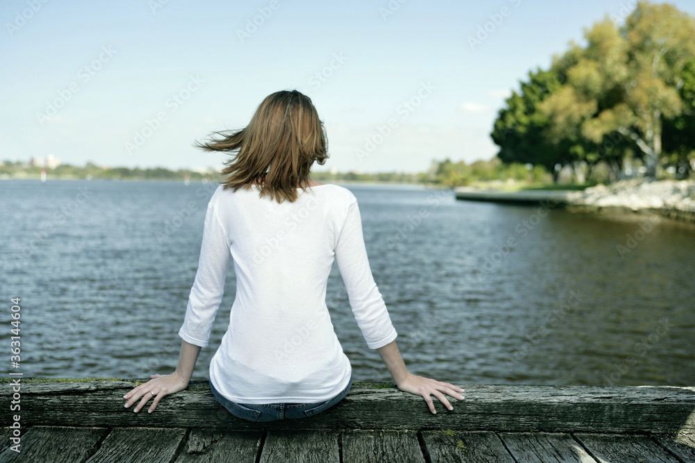 A teenage girl spending time leisurely beside the lake