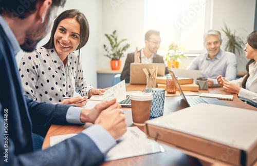 Business people discussing over new business project in office