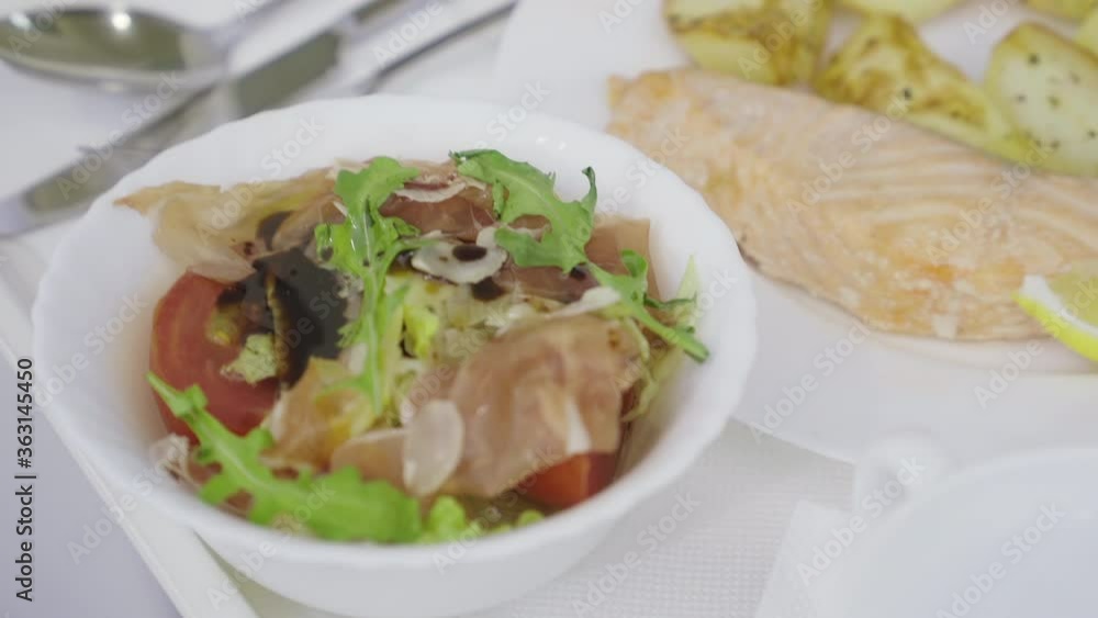 Extreme close-up of food in medical clinic. Hospital food on tray. Red fish with potato and salad for patients. Extreme close-up of food in medical clinic. Hospital food on tray. Red fish with potato and salad for patients.