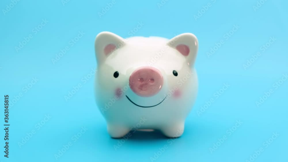 Zooming in on piggy bank against blue background. Saving money concept. Zooming in on piggy bank against blue background. Saving money concept.