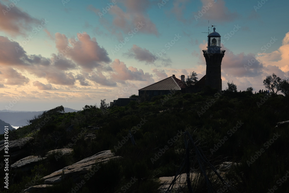 lighthouse in the mountain at sunset