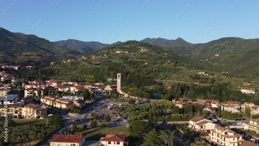 Approaching Aerial view of an Ancient roman entire stone church of Peter and Paul Saints at Cascia, Reggello containing famous italian Masaccio paintings. Tuscany, Italy. Sunset early summer Approaching Aerial view of an Ancient roman entire stone church of Peter and Paul Saints at Cascia, Reggello containing famous italian Masaccio paintings. Tuscany, Italy. Sunset early summer