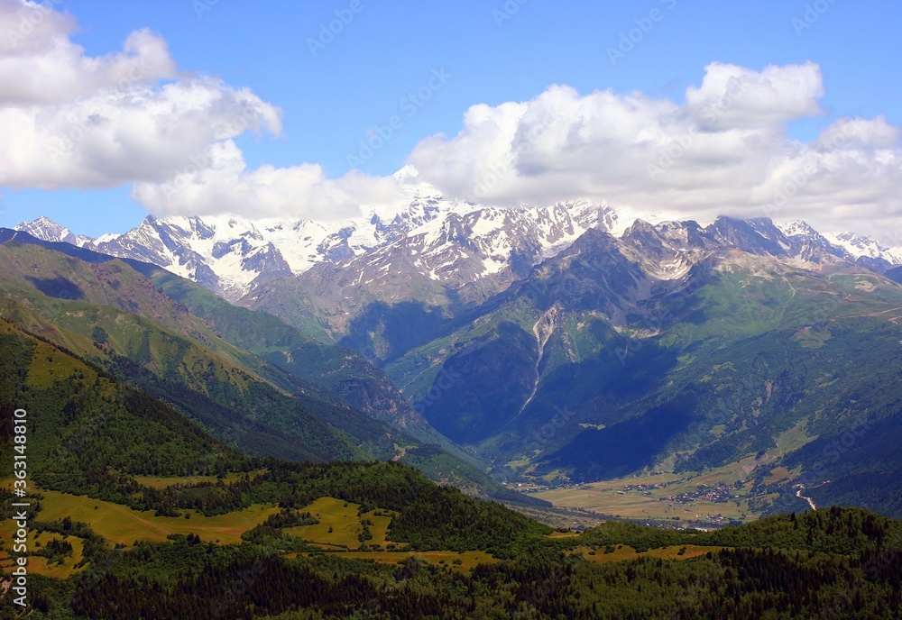 Mountain landscape, picturesque mountain in the summer, large panorama, Georgia. Summer greens. Travel and vacation in the mountains.