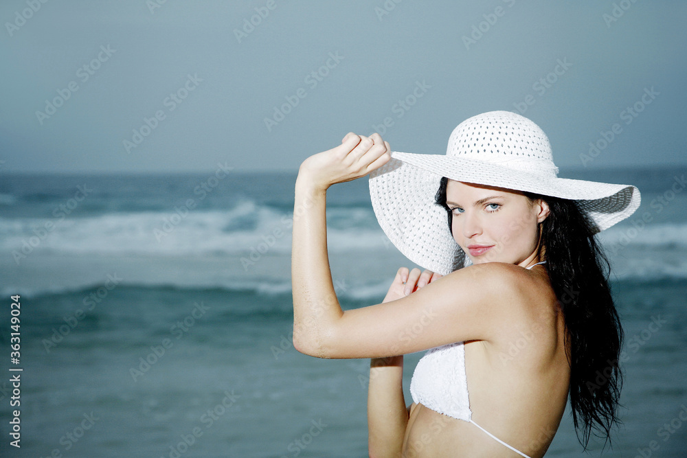 Woman in bikini and hat posing for the camera