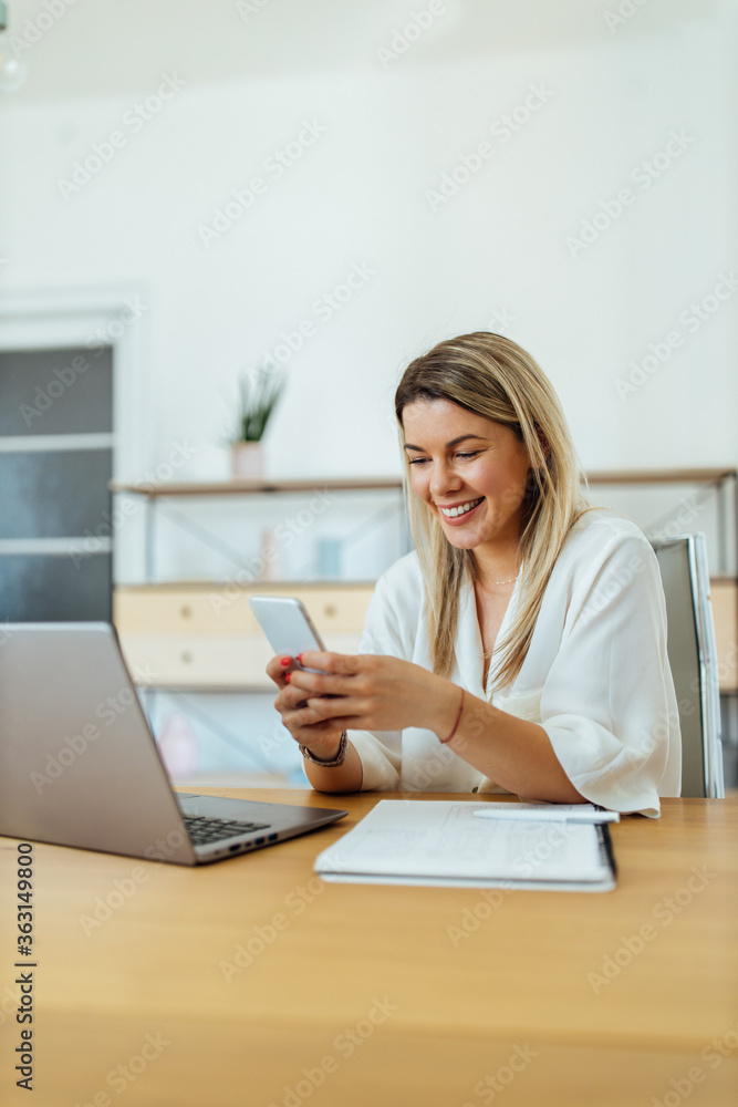 Businesswoman using smart phone at work, portrait. Businesswoman using smart phone at work, portrait.