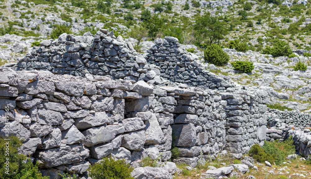 Ancient hand built stone houses found when hiking the croatian mountain of biokovo. Remains of area which were most likely used as horse stables