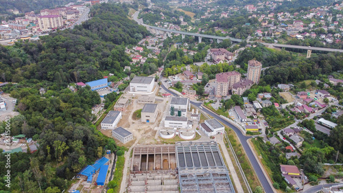 Aerial view of treatment facilities in close urban development. Engineering infrastructure in the mountains.