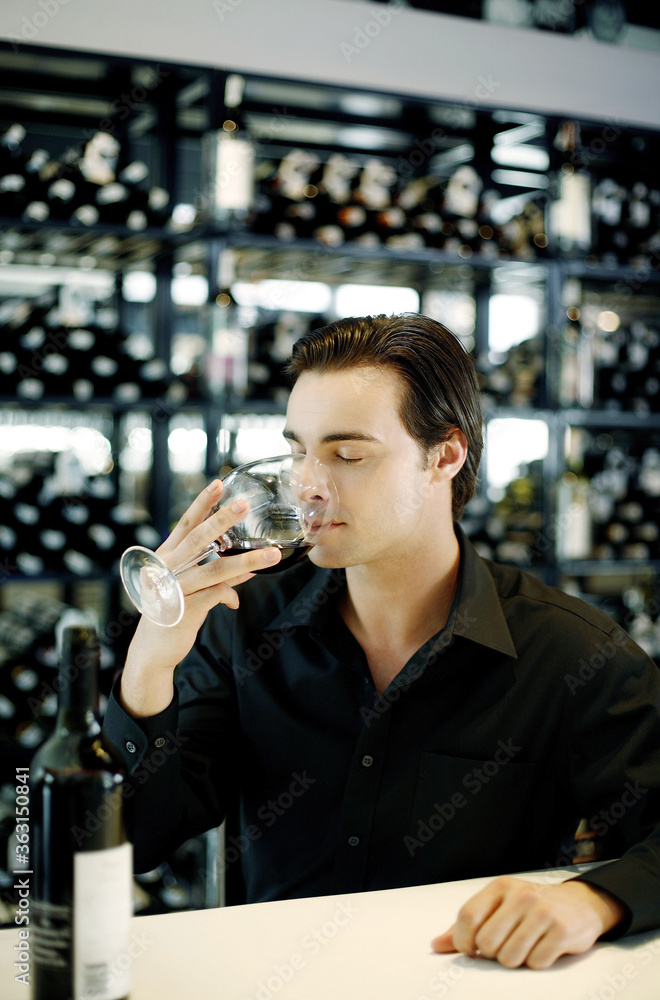 Man drinking a glass of red wine Man drinking a glass of red wine