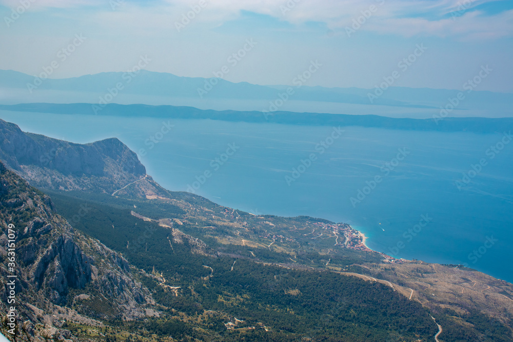 Panoramic view from the newly built Skywalk on Biokovo mountain in Croatia. View of the Adriatic sea, Podgora city. High mountains descending to sea level