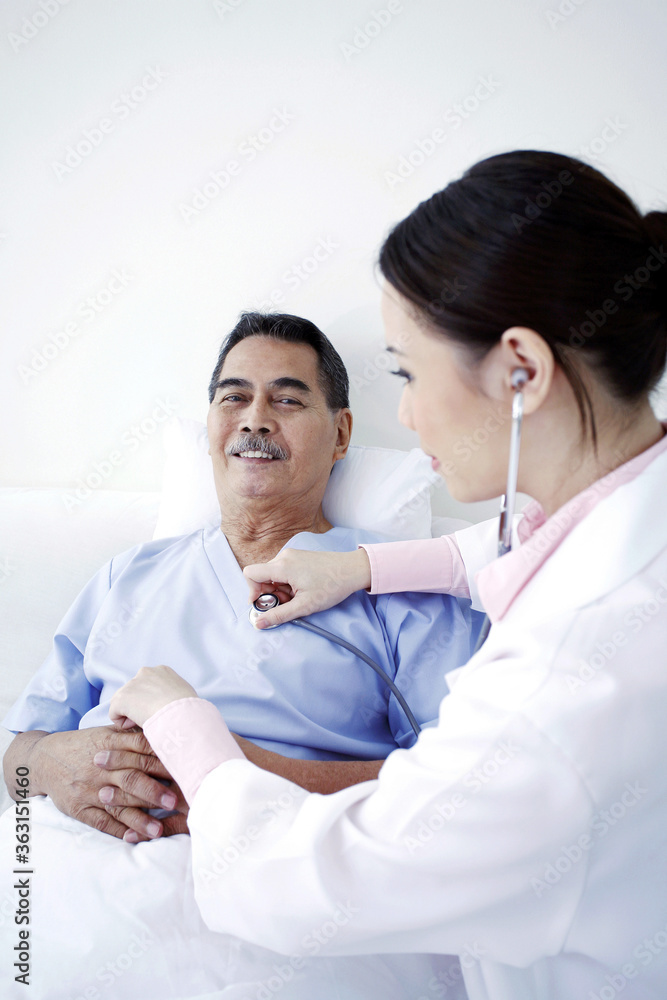 Doctor examining patient in a ward