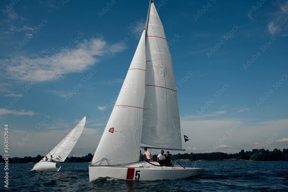Luxury yachts at Sailing regatta. Sailing in the wind through the waves at the Sea.
