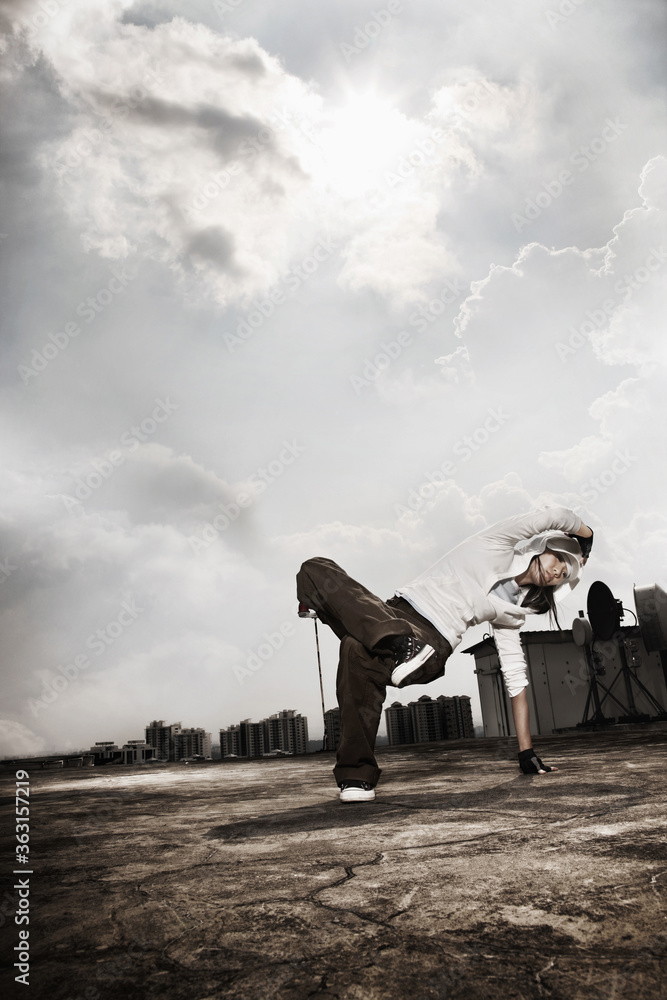 Young woman making a breakdance move Young woman making a breakdance move