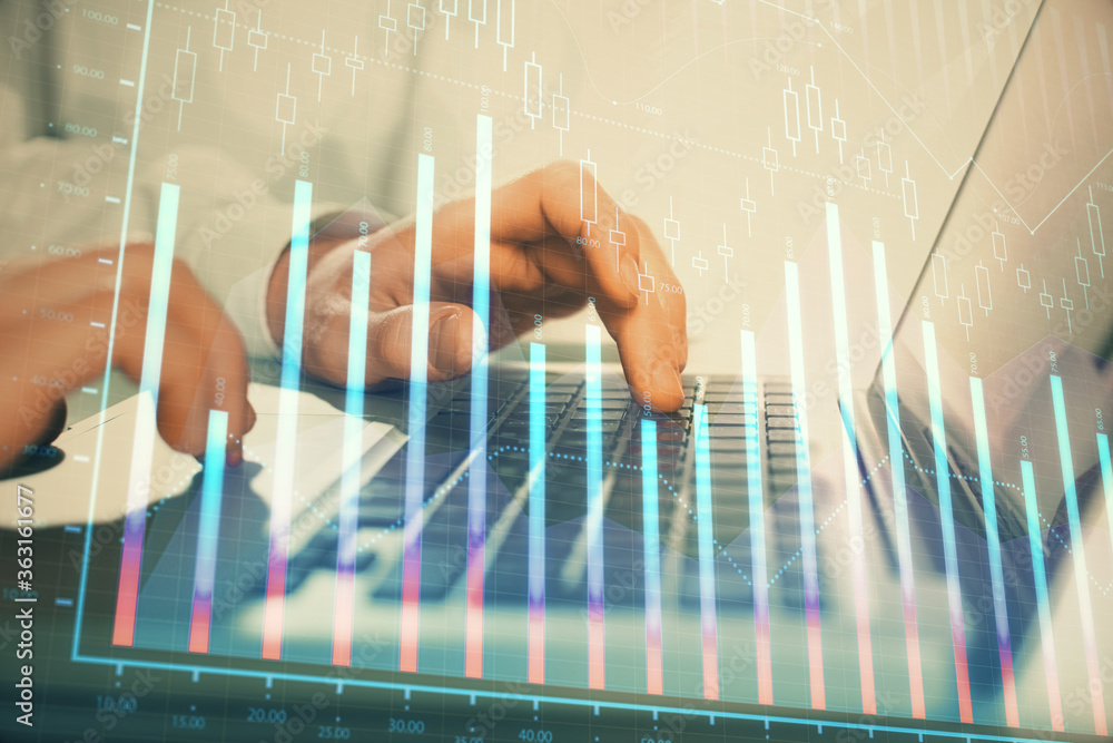 Double exposure of market chart with man working on computer on background. Concept of financial analysis. Double exposure of market chart with man working on computer on background. Concept of financial analysis.