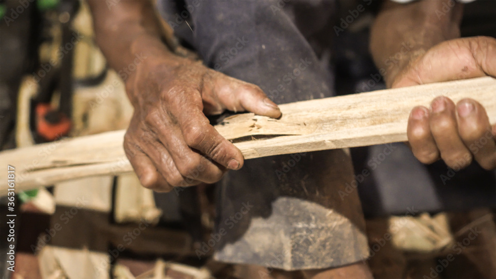 Elder man hand use knife cutting bamboo craftman work in Thailand Elder man hand use knife cutting bamboo craftman work in Thailand