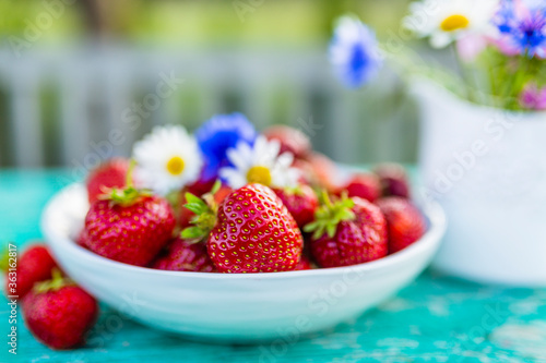 Delicious ripe strawberries on a table in the garden.
