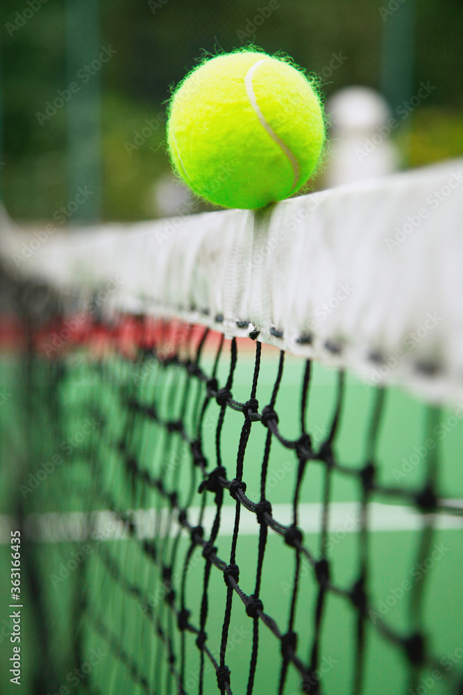 Tennis ball on tennis net
