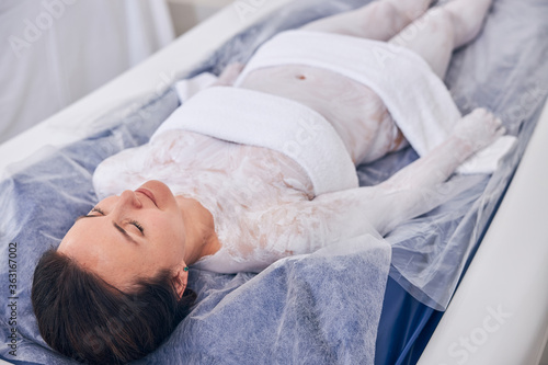 Calm lady enjoying dry floating in the spa