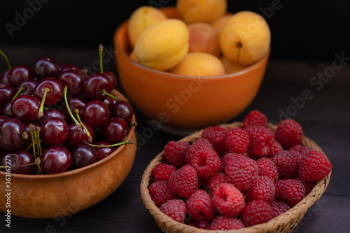 Ripe raspberries on a wooden background