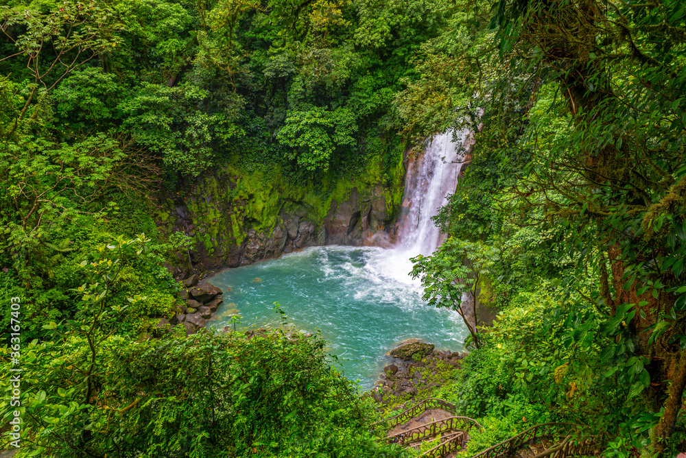 Waterfall and natural pool with turquoise, blue water of Rio Celeste in Tenorio Volcano national park, Costa Rica. Central America. Waterfall and natural pool with turquoise, blue water of Rio Celeste in Tenorio Volcano national park, Costa Rica. Central America.