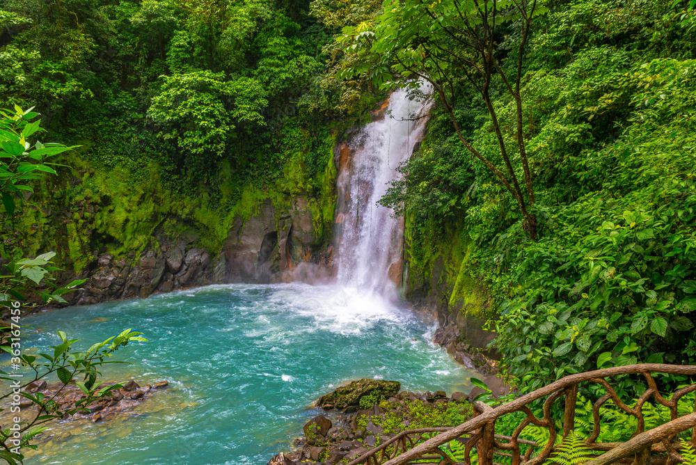 Waterfall and natural pool with turquoise, blue water of Rio Celeste in Tenorio Volcano national park, Costa Rica. Central America.