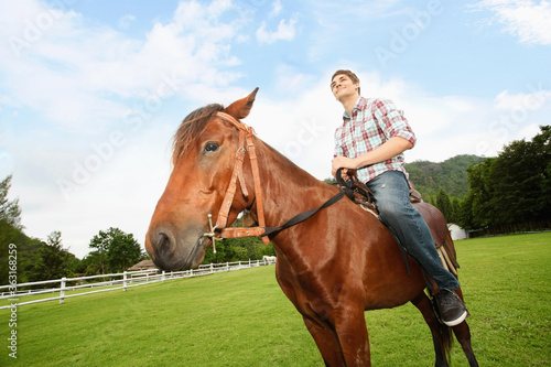 Man riding on a horse © ImageHit