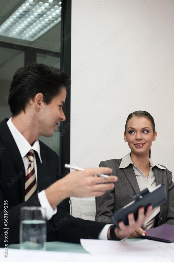 Businessman and businesswoman having discussion Businessman and businesswoman having discussion