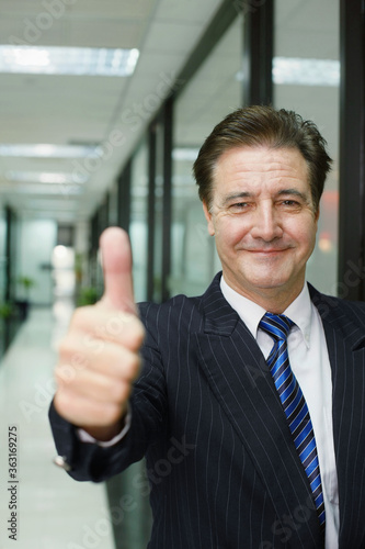 Businessman showing thumbs up