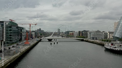 Samuel Beckett Bridge over Liffey River Dublin Ireland - Aerial drone view 4K - Forward movement  photo