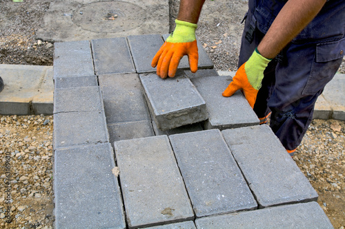 Laying concrete bricks for the sidewalk