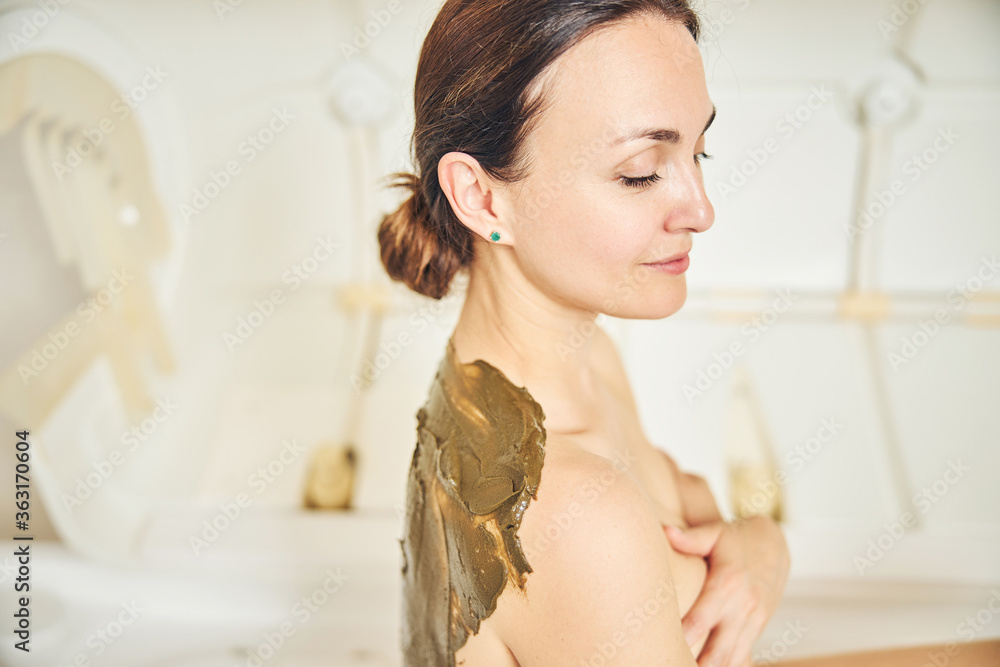 Spa treatment body wrap for smiling young woman Spa treatment body wrap for smiling young woman