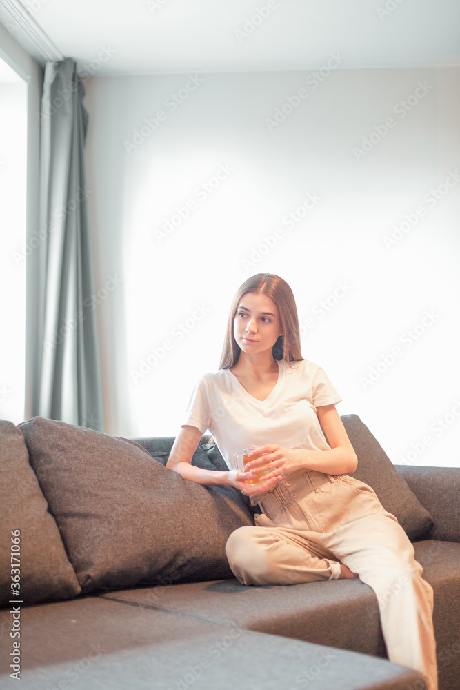 Young woman pretty relaxing on couch in living room Young woman pretty relaxing on couch in living room