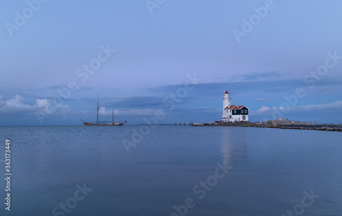 Obraz na płótnie Malownicza latarnia morska w Marken (The Hors of Marken), położona na półwyspie nad jeziorem Marken w Holandii Północnej. w salonie
