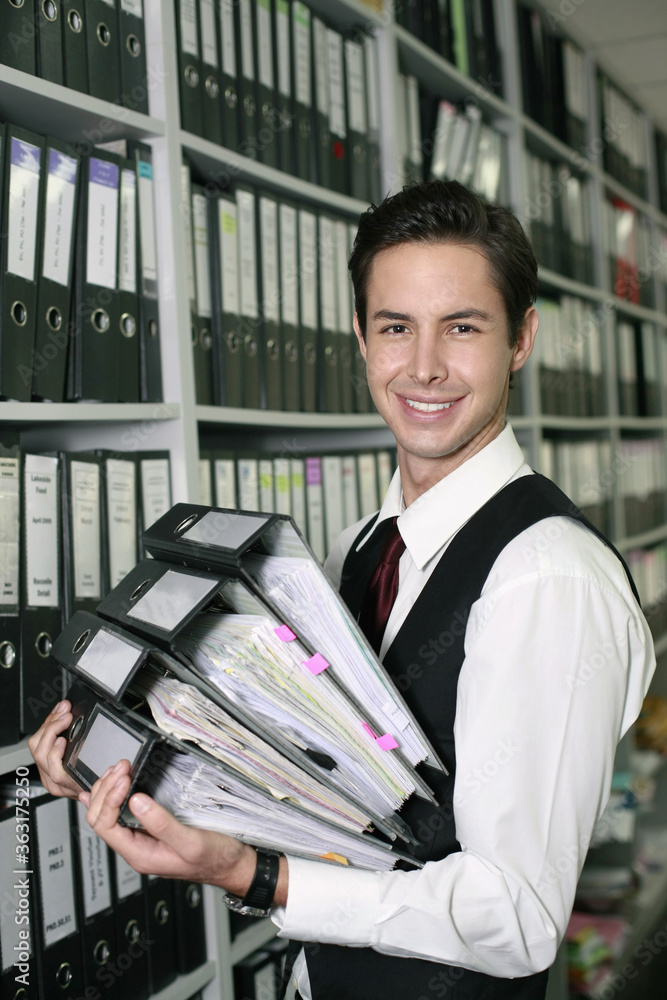 Businessman with a stack of files Businessman with a stack of files