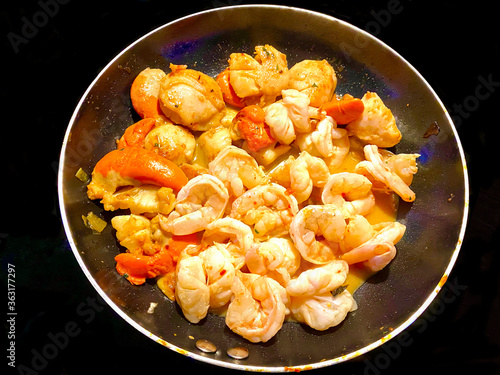 Deluxe pan of Isle of Man King Scallops and prawns being sautéed in delicious garlic butter and herbs