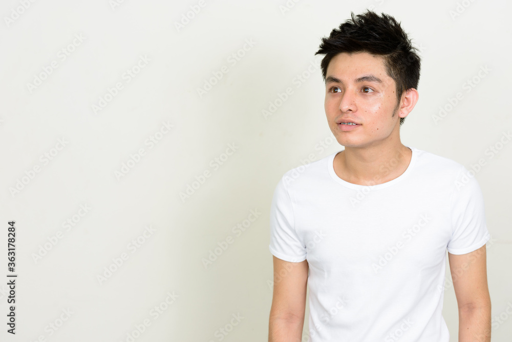 Obraz premium Portrait of happy young handsome Asian man with braces thinking