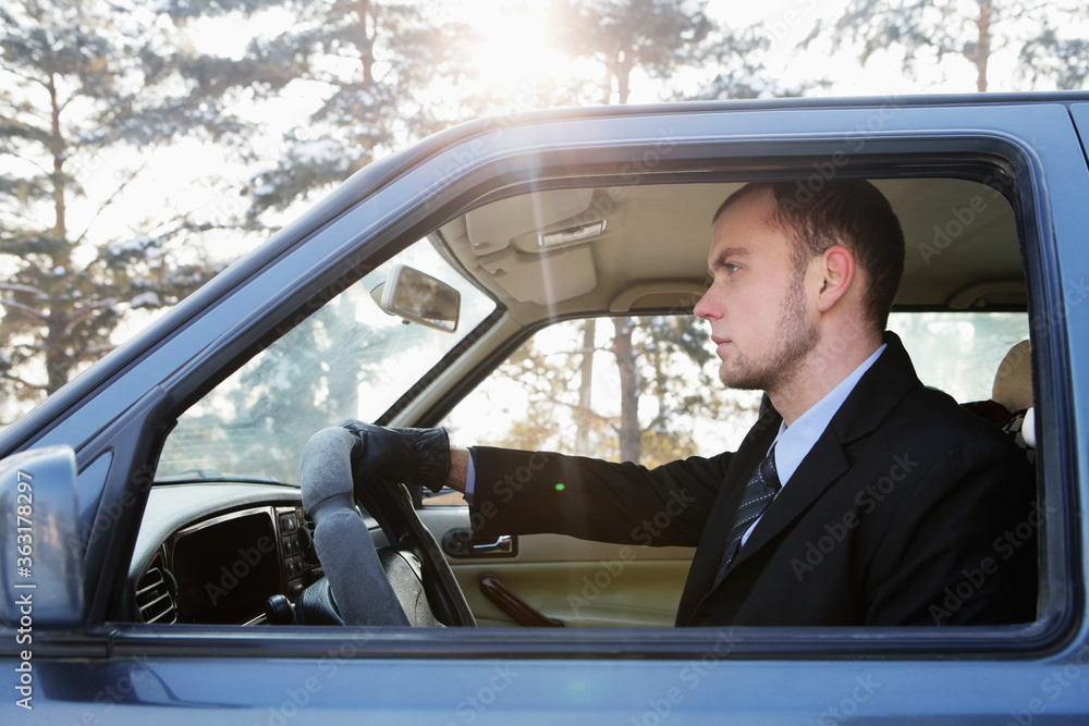 Businessman driving on winter day