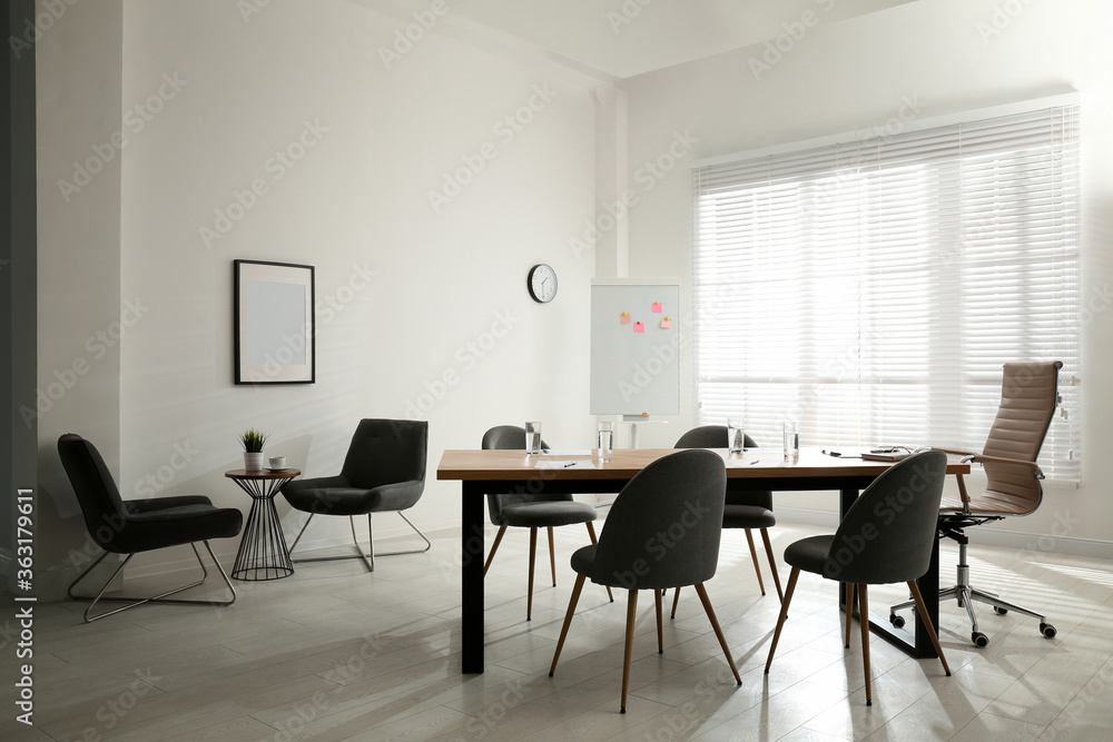 Simple office interior with large table and chairs