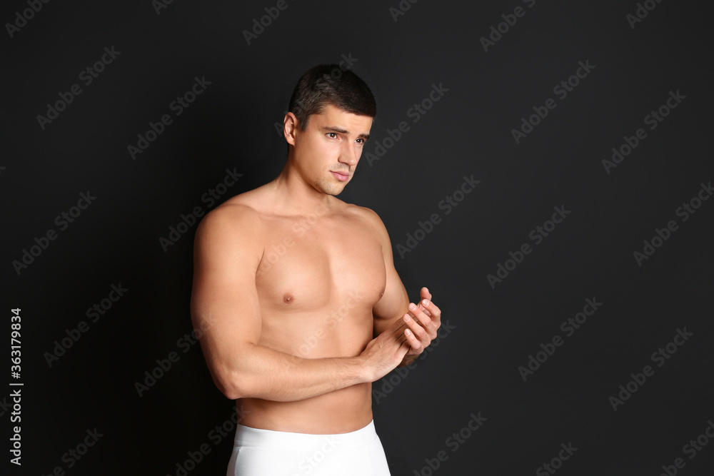 Fototapeta premium Man with sexy body on black background. Space for text