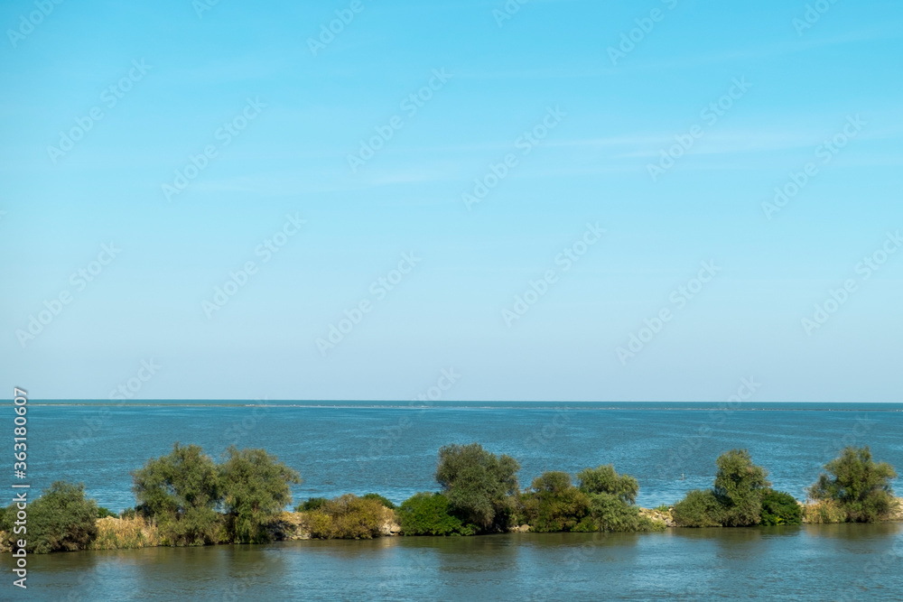 Landscape with the water channel between Danube Delta and Black Sea,  Romania,  in a summer sunny day