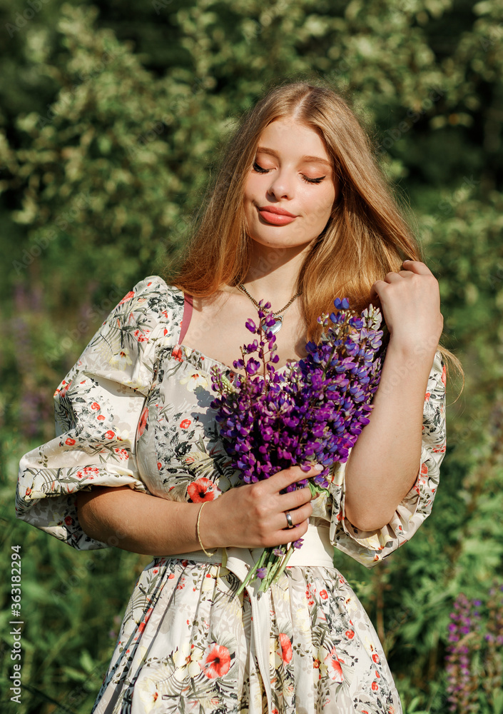 Lovely cute woman in lupine field, sunny day, freedom concept Lovely cute woman in lupine field, sunny day, freedom concept